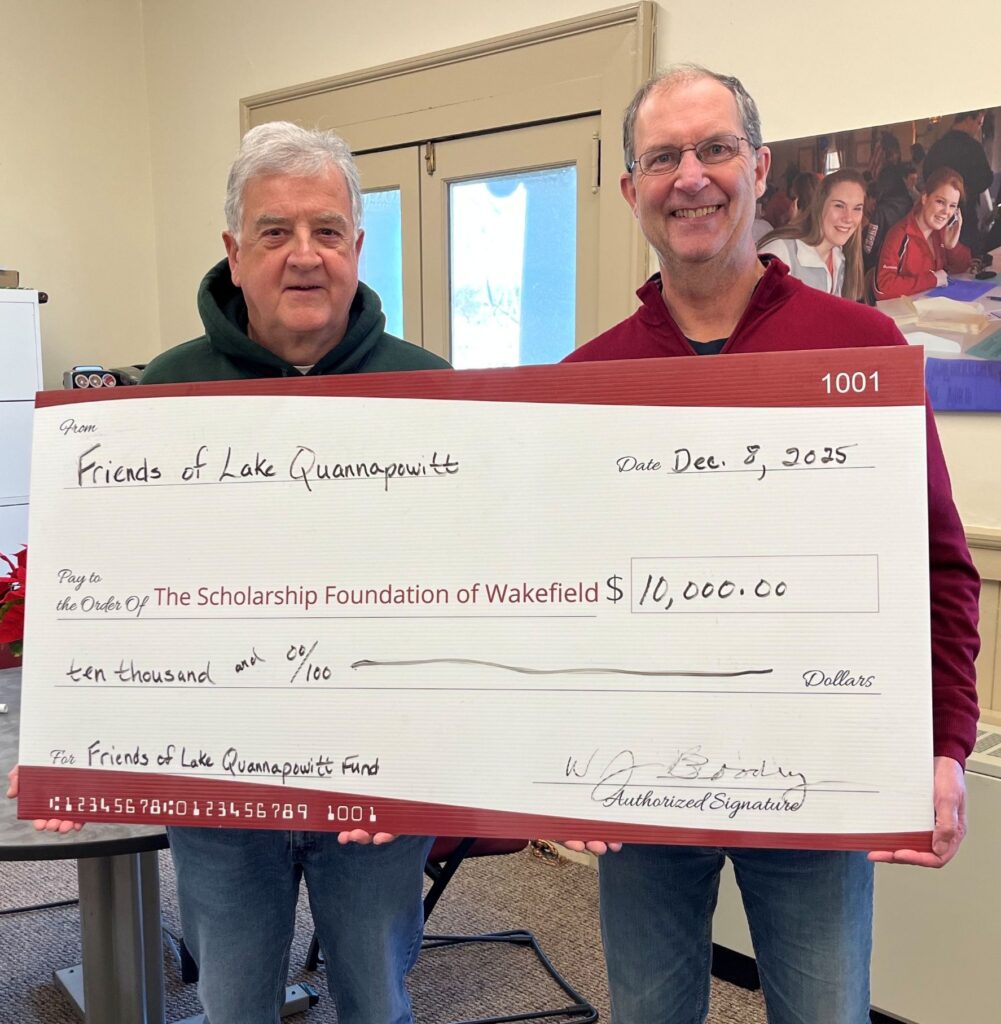 Two individuals present a ceremonial check from Friends of Lake Quannapowitt to The Scholarship Foundation of Wakefield, dated December 8, 2025, for $10,000.